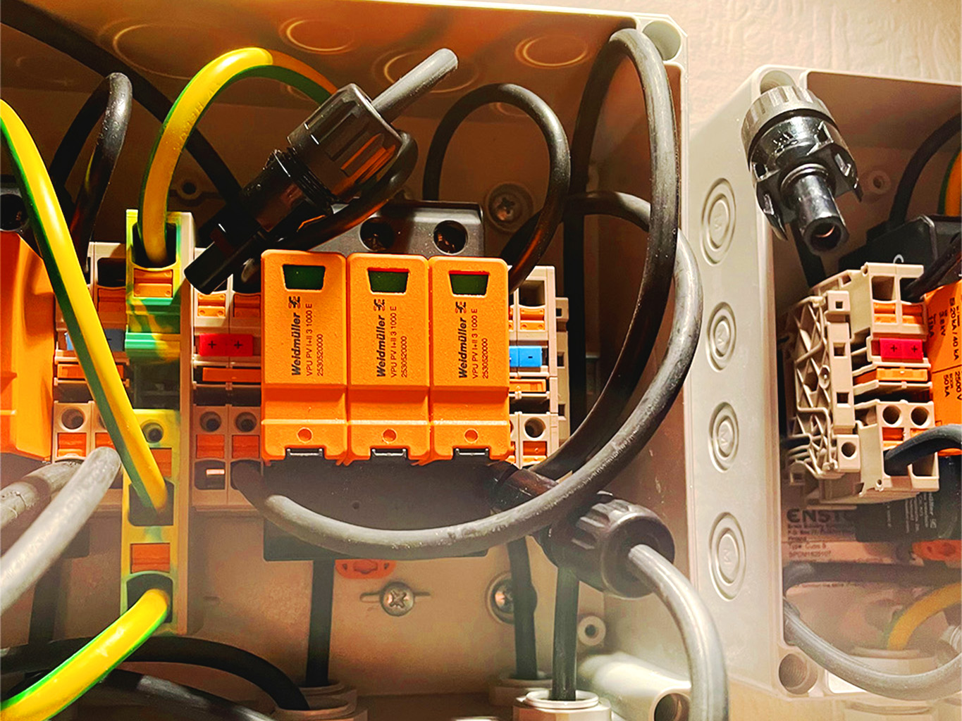 Detailansicht einer professionellen Elektroinstallation mit Verdrahtung, Schutzklemmen und farblich codierten Leitungen